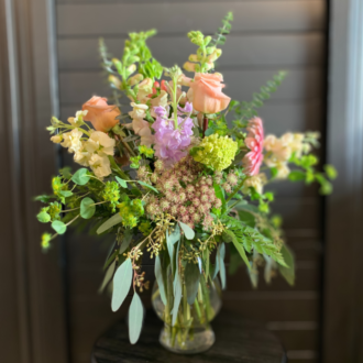 a vase of flowers by bloom wildly floral boutique